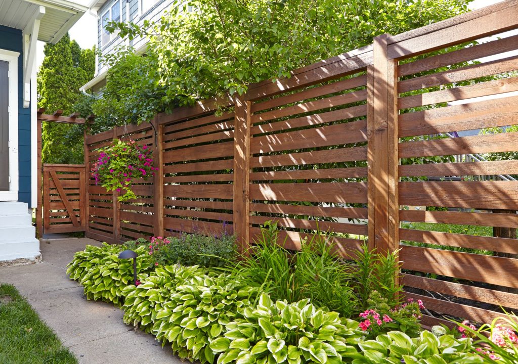 horizontal plank wooden fence in backyard