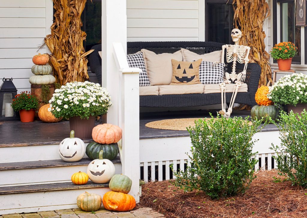 pumpkins mums and cornstalks on halloween fall front porch