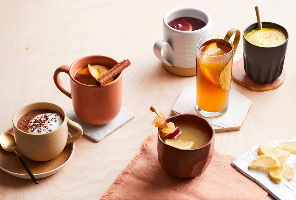 A collection of hot drinks on a wooden table