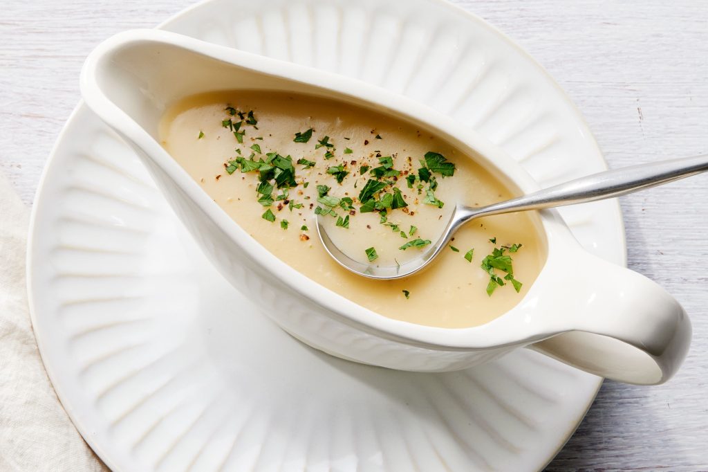 gravy in gravy boat with fresh parsley