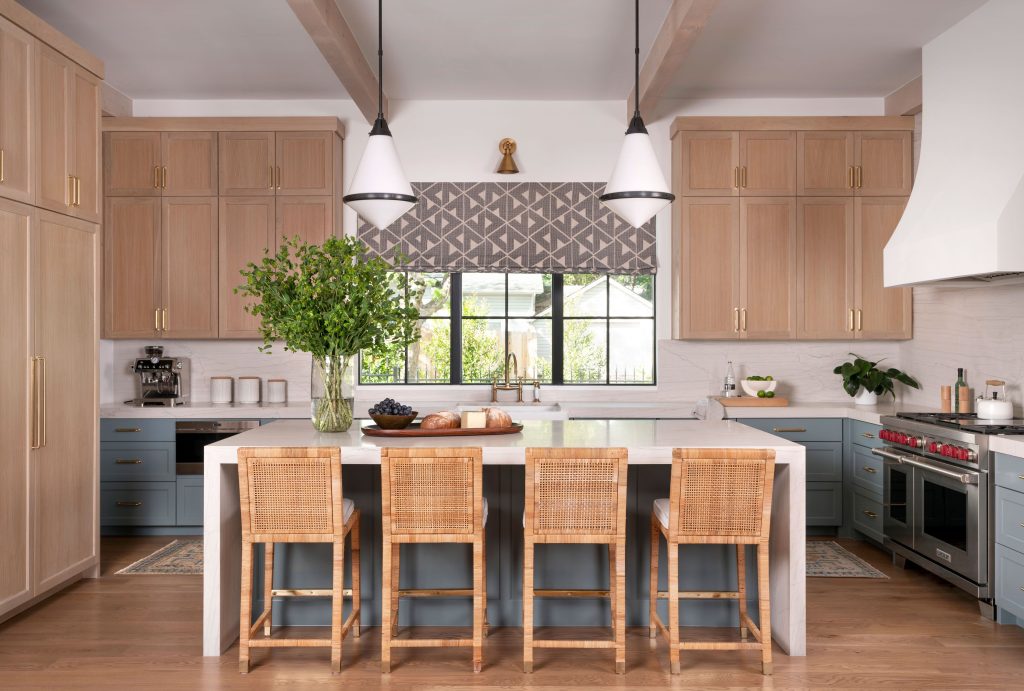 A modern kitchen with an island barstools pendant lighting and wooden cabinetry