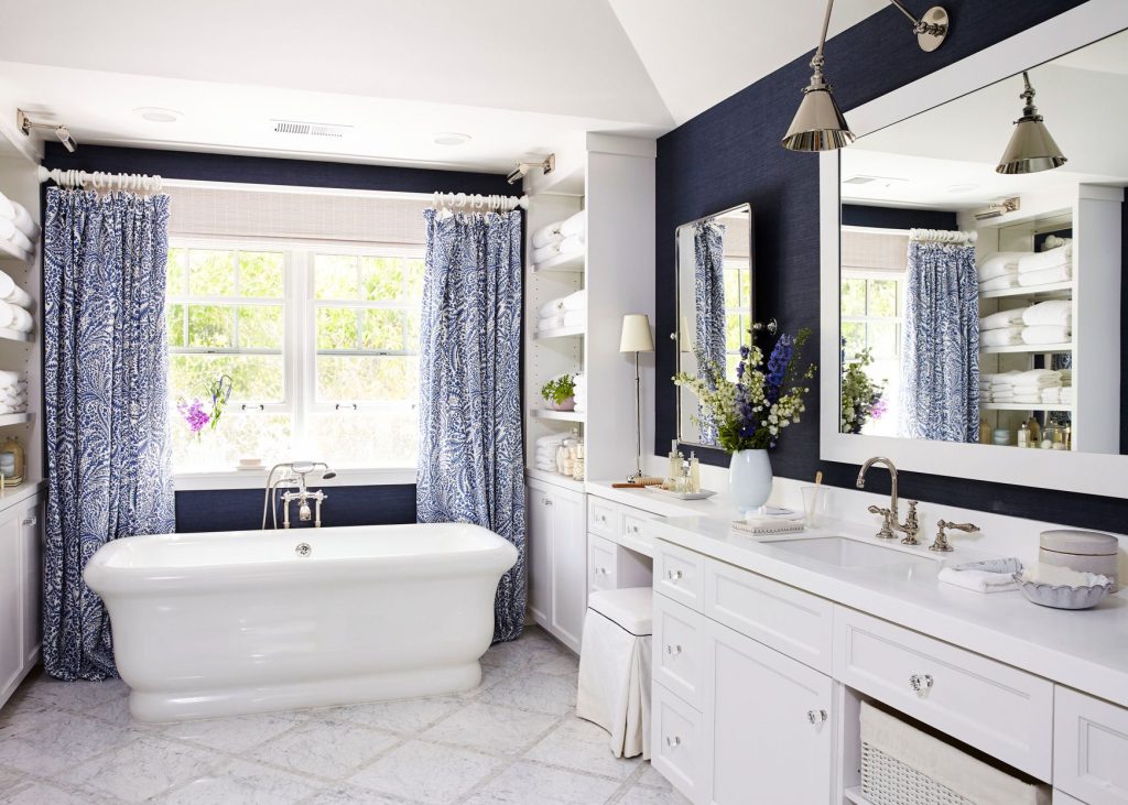 blue master bathroom with bathtub and large vanity