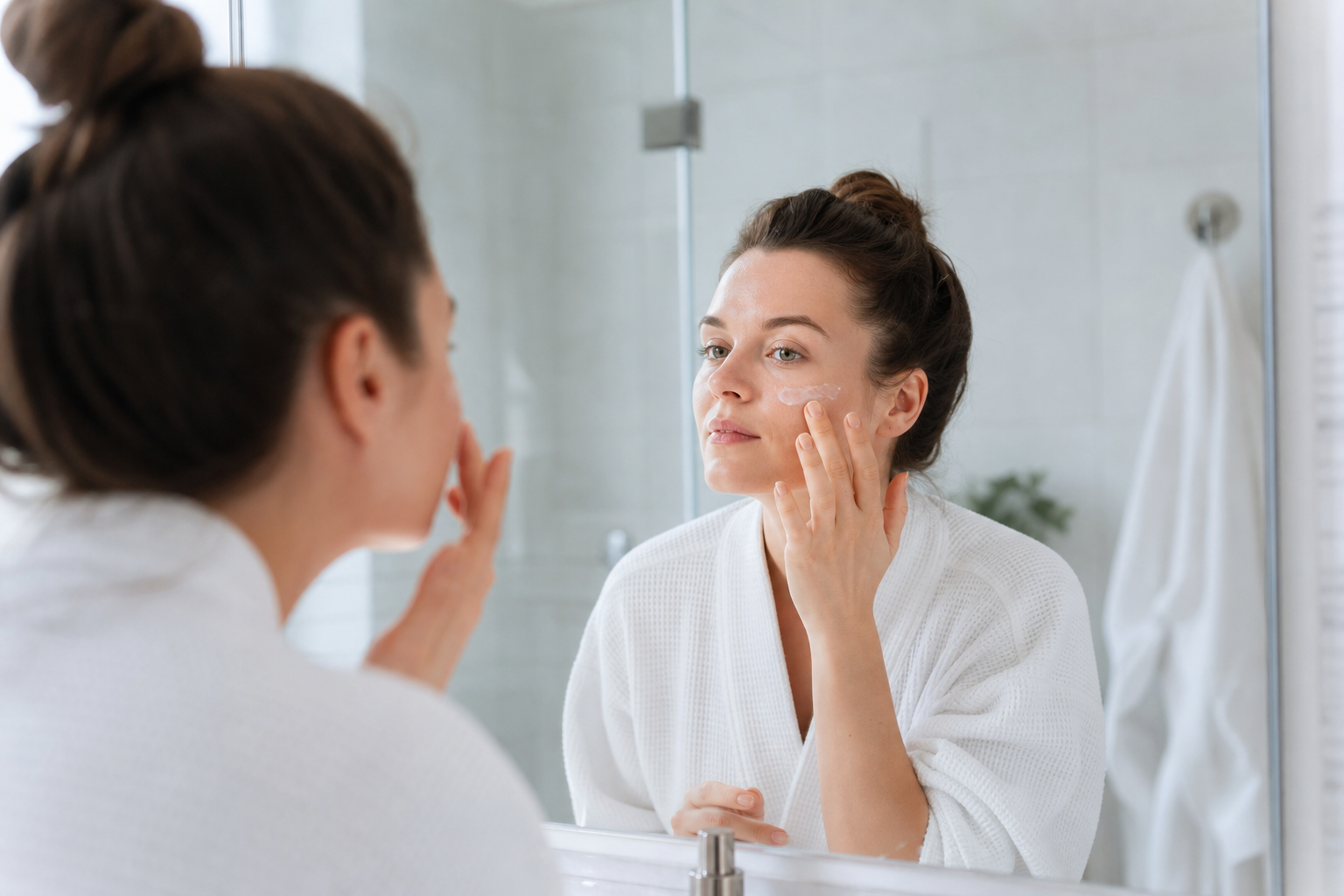 Person applying fragrance free moisturizer as part of a sensitive skin routine
