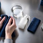 Holding a navy towel in stainless steel work surface for check skin type