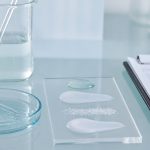 Testing liquid and cream samples in laboratory workbench for exfoliation skin barrier repair