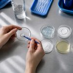 Mixing substances in a glass dish in laboratory workbench for skincare ingredients for acne