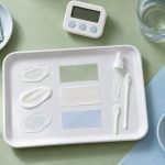 Displaying skincare materials in pastel tabletop arrangement for skincare niacinamide